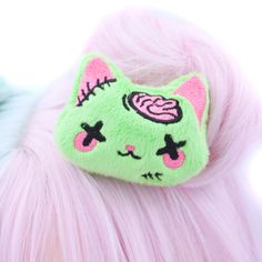 "Add a touch of adorable undead charm to your look with our Plush Anime Style Kawaii Zombie Kitty Hair Clip! Crafted from bright lime green minky fabric, this hair clip features a sweet-faced kitty with hot pink brains and stitches embroidered using the highest quality threads. Each detail is meticulously designed and digitized by me, ensuring a unique and delightful accessory. Handmade with love in the USA, this super cute zombie kitty hair clip is perfect for adding a playful twist to your ens Kawaii Plush Hair Clip, Yume Kawaii Hair Accessories, Yami Kawaii Accessories, Cute Halloween Costume Accessories, Cute Costume Accessories For Halloween Cosplay, Cute Zombie Aesthetic, Decora Hair Clips, Pastel Goth Accessories, Zombie Accessories