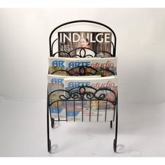 three magazine rack with magazines stacked on top