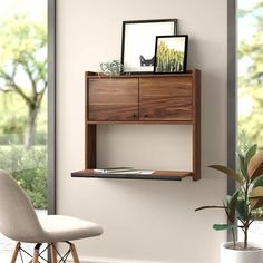 a wooden shelf sitting on top of a wall next to a chair and potted plant