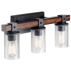 three light bathroom fixture with clear glass shades and wood accents on the back wall,