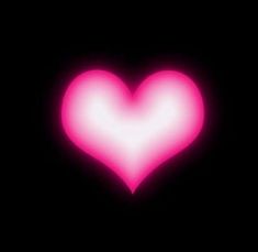 a pink heart shaped object in the dark