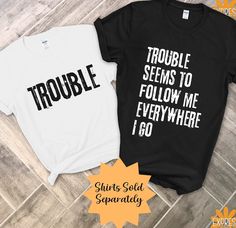 NOTE: SHIPPING ESTIMATES ARE BASED ON BUSINESS DAYS & EXCLUDE WEEKENDS/HOLIDAYS. PLEASE ALLOW up to 10 BUSINESS DAYS for your package to arrive. We can not guarantee delivery dates. Please keep in  mind that winter weather, wildfires, natural disasters, etc. can cause delays. Thank you for understanding! The "Trouble" T-shirt, with its bold and grunge-style text, sets the stage for some mischievous fun as part of a Funny Matching Couples T-Shirt ensemble. Paired with the coordinating "Trouble Se Funny Matching T Shirts, Matching Couples Shirts, Halloween Shirts Couples, Couple Tshirts Funny, Cheap Family Shirt With Funny Text, Funny Halloween Shirts For Couples, Funny Pre-shrunk Family T-shirt, Cursed Couple Shirts, Matching Sibling Shirts