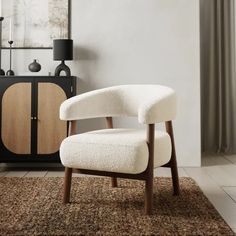 a white chair sitting on top of a brown rug