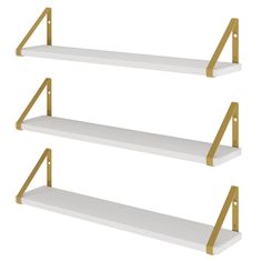 three white shelves with gold metal brackets