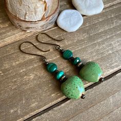 Heart earrings Malachite ceramic green earrings dangle boho earrings handmade antique bronze earrings gift unique jewelry for women Length: 40mm These beauties have 14mm handmade green ceramic kiln fired heart beads, 6mm-8mm malachite genuine stone beads, Celtic Bali beads, bronze findings and ear wires. Handmade and hammered. Unique boho earrings from SLDbeadwork. Earrings for women. Yes, please. I love to rock a great pair of earrings. Stone, crystal, lampwork, beaded earrings, well I love all Green Heart-shaped Bohemian Earrings, Green Spiritual Earrings With Natural Stones, Spiritual Green Earrings With Natural Stones, Bohemian Hypoallergenic Bronze Earrings, Bohemian Bronze Hypoallergenic Earrings, Hypoallergenic Bohemian Bronze Earrings, Earthy Green Dangle Earrings, Earthy Brass Jewelry Gift, Bohemian Hypoallergenic Bronze Jewelry