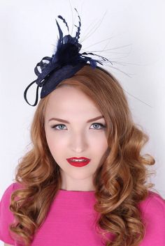 "\"Arianna\" Navy Blue Fascinator This season, sophisticated fascinators stole the show on the runways. Fascinators can be a little intimidating. But this cute little fascinator will help you overcome that fear. It perfectly lands the look, thanks to its mesh sinamay, frilly feathers, and loopy mesh ribbons. No matter the occasion, you will fit in with the fascinator craze with this simple yet stylish head-piece. Add Men's Matching Bow Tie: Don't you dare get caught mismatching your sweetie's fa Blue Spring Fascinator For Formal Occasions, Chic Blue Fascinator For Kentucky Derby, Blue Spring Formal Fascinator, Spring Blue Formal Fascinator, Formal Blue Spring Fascinator, Chic Blue Fascinator For Races, Chic Blue Fascinator For Formal Occasions, Chic Blue Formal Fascinator, Elegant Mini Hats For Kentucky Derby Costume Party