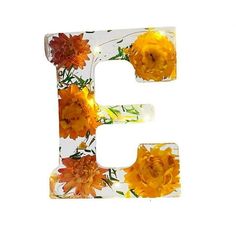 the letter e is made up of flowers and has been painted yellow with oranges