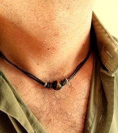 Surfeur style choker necklace made with natural tiger eye stone bead and brown wax cotton cord, stainless steel lobster clasp closure. All metal components are stainless steel. Simple every day cord necklace for men, brown stone choker for him.  Mens minimalist rope necklace a perfect gift for him. Tiger eye bead cord necklace, choker necklace for him, boyfriend gift. Tiger eye stone beads: 12 mm Tigers Eye is good for growing your confidence and strength and it is known as the stone of courage. It is a root and sacral chakra stone which means it helps you to get grounded, build a safe and strong foundation, and find your motivation once more. It's also good at warding off negative energy.  /Gift wrapping and packaging/ :   All items ordered will be placed in a gift bag and shipped in a bu Men Boho Necklace, Beach Jewelry For Men, Beaded Necklace Men’s, Male Choker Necklace, Mens Beaded Necklace, Men’s Beaded Necklace, Men’s Necklaces, Men’s Jewelry, Mens Bracelet Diy