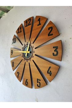 a clock that is on the side of a wall with numbers and times in it