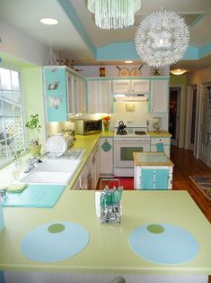 the kitchen is decorated in pastel colors and features an island with seating for four