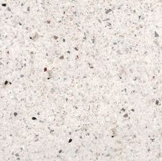 a close up view of a white marble counter top with black and gray speckles