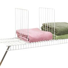 two towels are sitting on top of a rack with one folded in pink and the other green