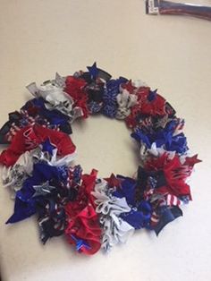 a patriotic wreath made out of red, white and blue hair bows on a counter