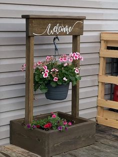 a potted planter sitting on top of a wooden stand next to a building