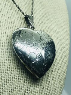 Vintage sterling silver heart pendant with a hand -engraved etched leafy scroll design on both sides of the pendant. Condition: Pre-owned -very good condition. Victorian Engraved Heart Jewelry, Victorian Engraved Heart Pendant Locket Necklace, Victorian Engraved Heart Pendant Jewelry, Antique Heart-shaped Engraved Jewelry, Antique Heart-shaped Engraved Necklace, Victorian Heart-shaped Engraved Necklace, Engraved Medallion Heart Necklace For Valentine's Day, Vintage Double Heart Engraved Locket Necklace, Vintage Engraved Open Heart Locket Necklace