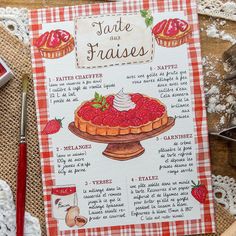 a recipe book with strawberry pies on it sitting next to some crocheted doily