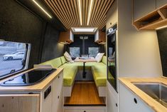 the interior of a camper with kitchen and living area