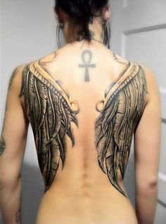 the back of a woman's body with an angel tattoo on her upper half