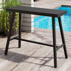 an outdoor table next to a swimming pool