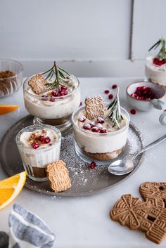 small desserts are arranged on a plate with cookies and cranberry toppings