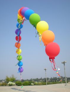 a bunch of balloons that are in the air