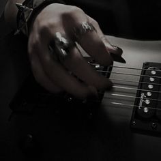 a person playing an electric guitar in the dark