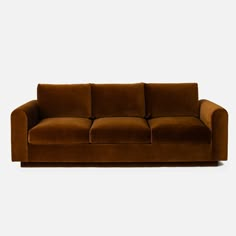 a brown couch sitting on top of a white floor