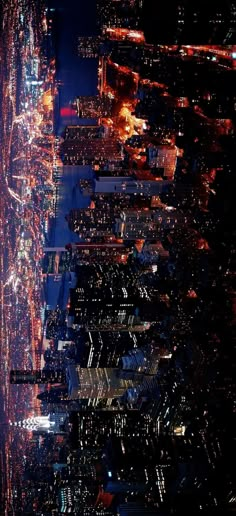 an aerial view of the city at night from above, with lights on buildings and skyscrapers