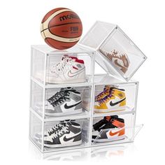 four clear acrylic boxes with basketballs and shoes in them on white background