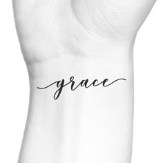 the word grace written in black ink on a hand