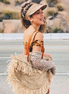 a woman carrying a straw bag on the street