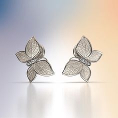 Experience Italian craftsmanship at its finest with our exquisite Diamond dangle drop earrings. The centerpiece of these earrings is a delicate butterfly with elegantly crafted leaves as its wings, creating a captivating and nature-inspired design. Available in both 14k and 18k gold, these earrings bring a touch of luxury and nature's beauty to your style. Elevate your look with the perfect blend of Italian artistry and organic elegance, shop now to adorn yourself with this unique masterpiece. 1 Elegant Silver Butterfly Earrings, Elegant Pierced Butterfly Jewelry, Elegant White Gold Earrings With Butterfly Charm, Elegant Silver Earrings With Butterfly Charm, White Gold Butterfly Fine Jewelry Earrings, White Gold Butterfly Earrings Fine Jewelry, Silver Butterfly Fine Jewelry Earrings, Luxury Yellow Gold Butterfly Earrings, Silver Butterfly Earrings Fine Jewelry