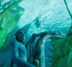 a man standing in front of an underwater scene with squids and other sea creatures