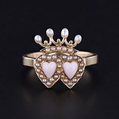 A fabulous love token ring featuring two hearts beneath a crown.  The face of this gorgeous ring was originally an antique stickpin (circa 1880-1900) transformed with a newly made custom 14k gold mounting.  The hearts are a pink hued coral framed by tiny half pearls, and the crown is also accented with half pearls and four post set pearls.    The face of the ring measures 0.6 inches from top to bottom and the piece is in great condition.  The ring is currently a size 6, but it can be re-sized free of charge.  We have many other fantastic offerings of period fine jewelry posted on our Etsy store, so please consider browsing our other items. We send all items in individually packaged gift boxes and offer layaway plans! + Trademark Antiques Shop Homepage https://www.etsy.com/shop/TrademarkAnt Double Crown Engagement Ring, Pink Baroque, Double Heart Ring, Glamorous Jewelry, Pearl Engagement Ring, Gorgeous Ring, Love Token, Custom Engagement Rings, Jewelry Post