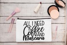 all i need is coffee and mascara makeup bag on white wooden table next to cosmetics