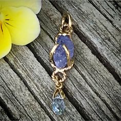 "Please go to my Instagram to watch the video about this pendant ~ A lovely genuine purple-blue color tanzanite glistens in a hollow 14k yellow gold wire bezel. Set with a light blue color sapphire bead is so fiery, vibrant and intense! A unique little piece with so much character. All handcrafted by me in my Michigan studio. Gem: approx. 12mm x 7mm / 2.15ct / genuine purple-blue tanzanite / with inclusions and imperfection surface 6mm x 3mm/ genuine light blue bead / with inclusions and imperfe Handmade Tanzanite Yellow Gold Jewelry, Lavender Tanzanite Jewelry For Gifts, Necklace Sapphire, Boulder Opal Ring, 14k Yellow Gold Necklace, Halo Necklace, Yellow Gold Necklace, Blue Tanzanite, Sapphire Pendant