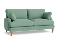 a light green couch with wooden legs on an isolated white background for use in interior design