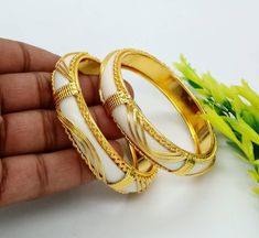 ❖ ❖ ❖ Features: ❖ An Indian styled Polki Bangles. ❖ Made from fine Quality Brass with Gold Platting. ❖ Ready to be given as a gift. ❖ Easy and Convenient way to Wear. ❖ It looks prettier than the images. Direct Images on hand is also attached. Size of Bangle & Other Details: ❖ Size:- Choose Your Size ❖ Quantity:- 6 pieces 1 bangle set ❖ Material:- Fine Quality Brass with Gold Platting This gold plated unique bangles are glamorously impressive, yet subtle, the design is clean and extremely ac White Bangle Jewelry For Marriage, White Bangle For Marriage, White Bangle For Marriage And Festive Occasions, White Bracelets For Marriage Festive Occasion, White Bracelets For Marriage And Festive Occasions, White Bracelet For Marriage And Festive Occasions, White Festive Bangle For Marriage, White Bangle For Marriage And Festivals, White Bangle With Intricate Design