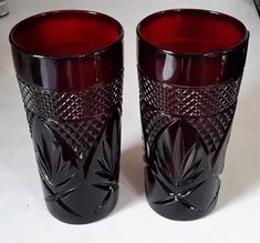 two red glass cups sitting next to each other