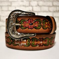 EMBOSSED LEATHER BELT FOR WOMEN This leather belt for women is a dream accessory; a versatile piece you'll love and wear forever. Sumptuous LEATHER in rich brown tones is embossed with flowers and finished with a classic engraved buckle. The vintage vibe and Western-inspired design make it the perfect partner to your trusty blue jeans and boho dresses. •Made of GENUINE LEATHER and has a metal buckle•HANDMADE by talented artisans for an authentic look•EMBOSSED LEATHER , engraved buckle,•Features Luxury Vintage Engraved Belts, Bohemian Antique Belt Buckles For Festivals, Bohemian Adjustable Belt With Antique Buckle, Adjustable Bohemian Belt With Antique Buckle, Bohemian Adjustable Belt Buckle With Belt Included, Vintage Brown Belt For Gift, Vintage Brown Belt As Gift, Vintage Brown Belt As A Gift, Bohemian Belt Buckles For Festivals