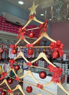 a christmas tree made out of wooden clothes hangers