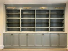 an empty bookcase in the middle of a room with no one sitting on it