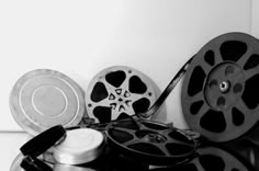 black and white photograph of film reels and other items