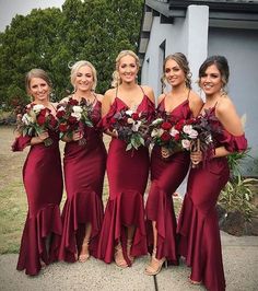 the bridesmaids are wearing red dresses and holding bouquets