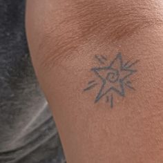 a person with a sun tattoo on their arm