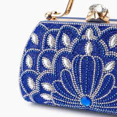 Introducing the Augustine Pearls Handbag - an enchanting masterpiece crafted to elevate your evening attire to unprecedented levels of sophistication. This clutch exudes magnificence in every detail, adorned with shimmering rhinestones and delicate pearl accents. Remarkably lightweight, it guarantees seamless carrying all through the night without compromising on style. Now available in blue, black, silver, and red. Bangle Ring, Handbag Collection, Evening Attire, Love Ring, Necklace Earring Set, Bag Set, Clutch Handbag, Name Necklace, Gemstone Colors