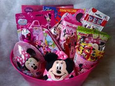 a pink bucket filled with lots of toys and stuff to make it look like minnie mouse