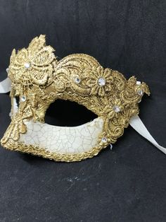 Colombina,half Face Venetian Mask,lace macrame,gold leaf or silver leaf. Traditional and original papier-mache Venetian mask, handmade and decorated with Burano lace,gold or silver leaf, cracked technique and swarovski crystal. All our masks are handmade papier-machè masks made in Venice. Our decorators use techniques typical of the Venetian tradition such as stucco, acrylics, gold and silver-leaf, macramè, passementerie, pearls and crequelè to give you a wide range of masks. This shape is avail Traditional Gold Masks And Prosthetics For Costume, Traditional Gold Costume Masks And Prosthetics, Traditional Gold Masks And Prosthetics For Carnival, Vintage Gold Masks For Costume Party, Vintage Gold Masks And Prosthetics For Costume Party, Traditional Gold Mask, Gold Venetian Masquerade Mask For Carnival, Traditional Gold Masks And Prosthetics For Festivals, Gold Masks And Prosthetics For Carnival Costume