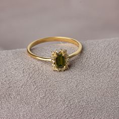 "With its shimmering pale green color, peridot stone is also known as the \"evening emerald\". It is a gemstone often associated with spirituality and expression. Our rectangular peridot stone ring surrounded by real diamonds will add elegance to your hands. It is a ring that you can use both on special occasions and in daily life. It is a beautiful and stylish product that you can gift to yourself and your loved ones. The color of those born in August is Peridot. Our necklace compatible with ou Dainty Wedding Ring Emerald, Vintage Green Rings, Engagement Rings Gold Colored Stone, Peridot And Diamond Engagement Rings, Virgo Engagement Ring, Diamond And Peridot Engagement Rings, Green Birthstone Ring With Gemstone Accents For Formal Occasions, Green Emerald Ring With Gemstone Accents For Anniversary, Rectangular Emerald Ring With Halo Setting