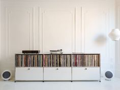 a record player sitting on top of a white cabinet